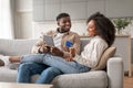 Smiling black couple using digital tablet and credit card indoors Royalty Free Stock Photo