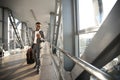 Smiling Black Entrepreneur Using Phone App Walking In Airport Indoors Royalty Free Stock Photo