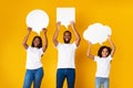 Smiling black family hoding different speech bubbles at studio Royalty Free Stock Photo
