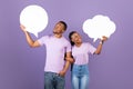 Smiling black family hoding speech bubbles at studio Royalty Free Stock Photo