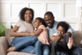 Smiling black family with kids having fun at home. Royalty Free Stock Photo