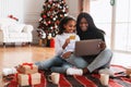 Smiling black family using pc and credit card on Xmas Royalty Free Stock Photo