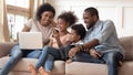 Smiling black family watch funny video on smartphone Royalty Free Stock Photo