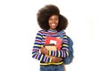 Smiling black female college student with books and bag against isolated white background