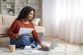 Smiling Black Freelancer Woman Working With Laptop And Papers At Home Royalty Free Stock Photo