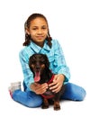 Smiling black girl hugging friendly dachhund Royalty Free Stock Photo