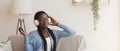 Smiling Black Girl Wearing Wireless Headphones, Enjoying Listening Music From Smartphone Royalty Free Stock Photo