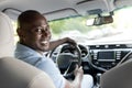 Smiling black guy driver sitting inside brand new car Royalty Free Stock Photo