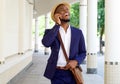 Smiling black guy walking and talking on mobile phone Royalty Free Stock Photo