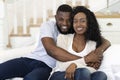 Smiling black husband and wife looking at camera and embracing Royalty Free Stock Photo