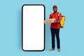 Smiling Black Male Courier Holding Pizza Boxes While Standing Near Blank Smarthone Royalty Free Stock Photo