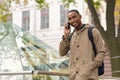 Smiling black male student talking on mobile phone Royalty Free Stock Photo