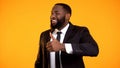 Smiling black man in business suit in suit making thumbs-up and looking to cam Royalty Free Stock Photo