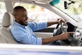 Smiling black man driving new car in city Royalty Free Stock Photo