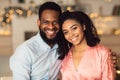 Smiling black man hugging his woman, looking at camera Royalty Free Stock Photo