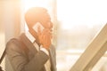 Smiling Black Man Talking On Phone Walking In Airport Indoor Royalty Free Stock Photo