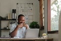 Smiling black man using laptop at home in living room. Happy mature businessman send email and working at home. African Royalty Free Stock Photo