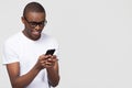 Smiling black man using phone isolated on background with copyspace