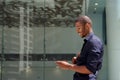 Smiling black man walking outside with cellphone Royalty Free Stock Photo