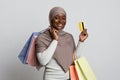 Smiling Black Muslim Woman In Hijab Holding Shopping Bags And Credit Card Royalty Free Stock Photo