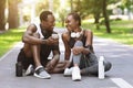 Smiling Black Sporty Couple Resting With Smartphone After Fitness Training Outdoors Royalty Free Stock Photo