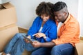 Smiling Black Spouses Moving Home And Using Digital Tablet Together Royalty Free Stock Photo