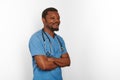 Smiling black surgeon doctor bearded man crossed arms in blue coat with stethoscope white background Royalty Free Stock Photo