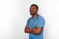 Smiling black surgeon doctor bearded man crossed arms in blue coat with stethoscope white background Royalty Free Stock Photo