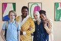 Smiling black woman with diverse group of teenagers in art gallery