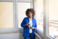 Smiling Black Woman Drinking Coffee While Standing Near Window At Home Royalty Free Stock Photo