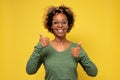 Smiling black woman giving thumbs up gesture Royalty Free Stock Photo