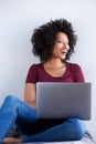 Smiling black woman relaxing at home with laptop computer Royalty Free Stock Photo