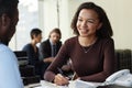 Smiling black woman working with client at legal firm