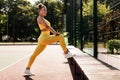 Smiling Black Woman In Yellow Sportswear Stretching Leg Outdoors Royalty Free Stock Photo