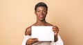 Smiling black young transgender model with blank poster Royalty Free Stock Photo