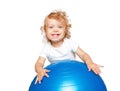 Smiling blond baby with gymnastic ball. Royalty Free Stock Photo