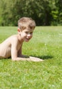 Smiling blond boy lying on the grass Royalty Free Stock Photo