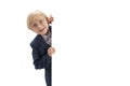 Smiling blond boy with white blank space. Boy with glasses and school uniform peeking out from behind board. Isolated white Royalty Free Stock Photo