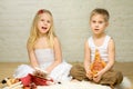 Smiling blond children play with toys