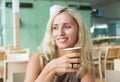 Smiling blond drinking coffee Royalty Free Stock Photo