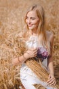 Smiling blond lady with sheaf of wheat sticks Royalty Free Stock Photo