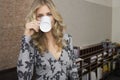 Smiling Blond Woman Drinking Coffee In Office Royalty Free Stock Photo