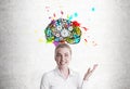 Smiling blond woman showing brain with cogs Royalty Free Stock Photo