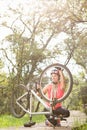 Smiling blonde athlete checking her mountain bike Royalty Free Stock Photo