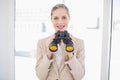 Smiling blonde businesswoman holding binoculars Royalty Free Stock Photo