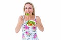 Smiling blonde eating bowl of salad Royalty Free Stock Photo