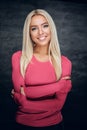 Smiling blonde female with crossed arms. Royalty Free Stock Photo