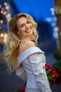 Smiling blonde girl with a bouquet of red roses Royalty Free Stock Photo