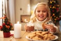 Smiling blonde girl holding mug with cacao and cookie, looking a Royalty Free Stock Photo