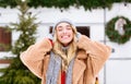 Smiling blonde girl in knitted hat enjoying snowy morning at winter campsite